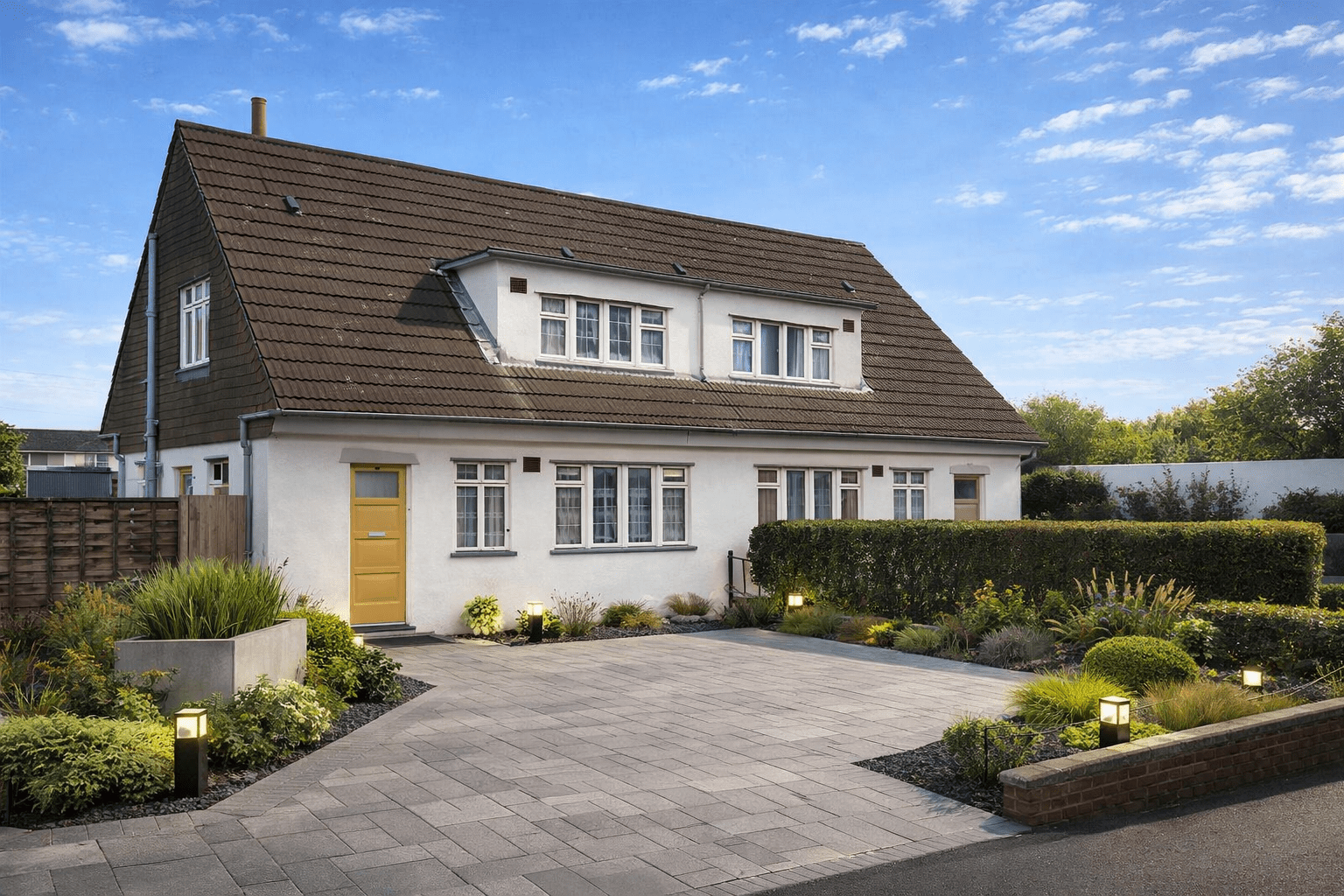 Falkiner-Nuttall semi-detached chalet bungalow with rendered walls and steep gable roof